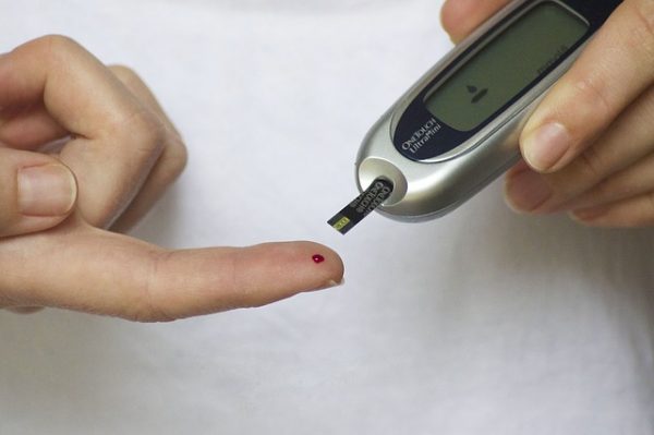 person with diabetes testing blood sugar