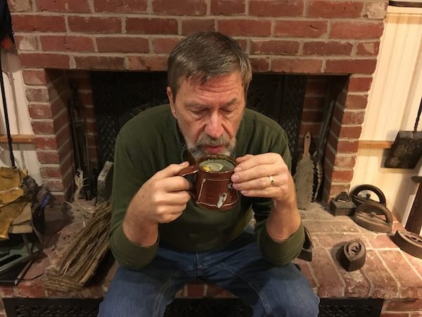 Diane Atwood's husband sipping tea because of a cold