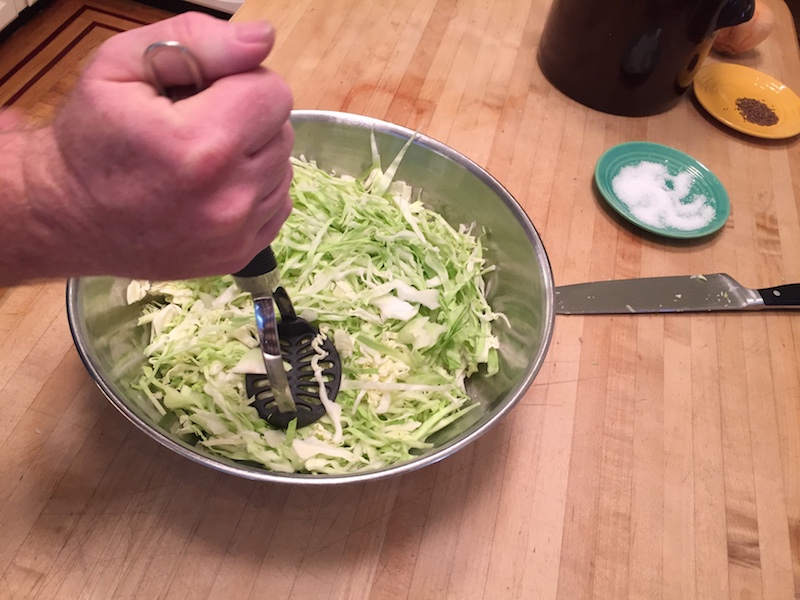Mashing cabbage for sauerkraut