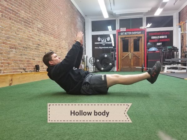 Andy demonstrating hollow body exercise