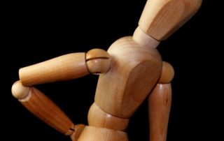 Wooden model holding onto back