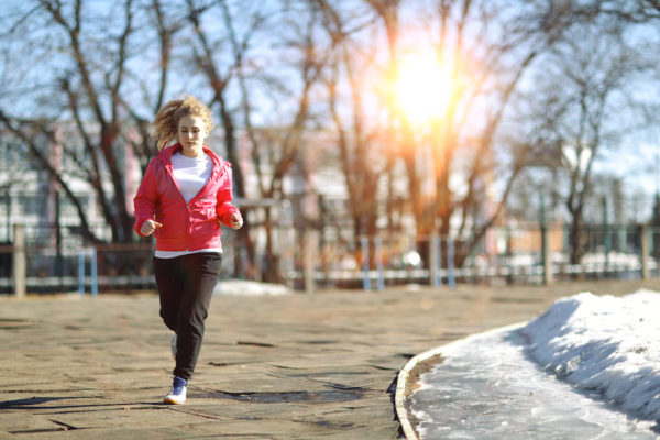 Woman running in early spring
