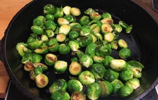 Brussels sprouts braising in pan