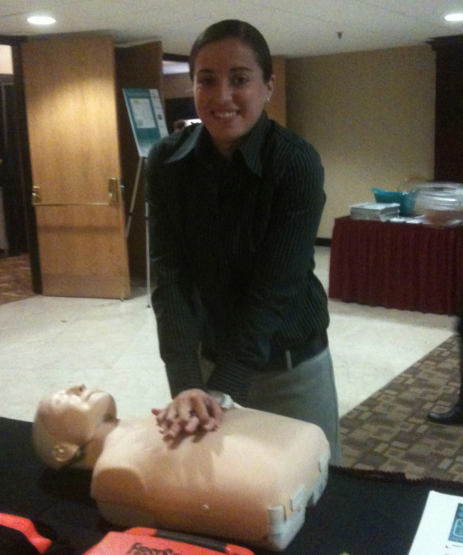 Amelia Santos, marketing intern for Maine Red Claws, learns Hands-Only CPR