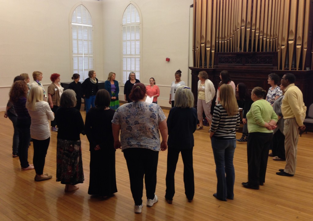 Group of adults standing in a circle/art/music/movement therapy