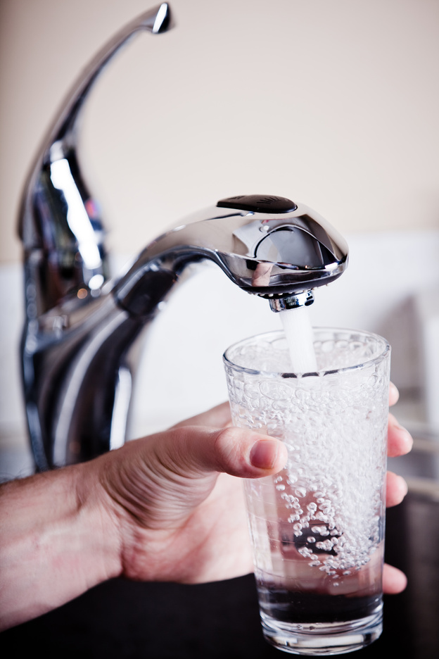 Man filling glass of water