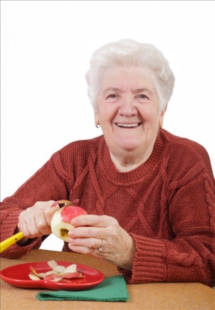 Older woman paring an apple