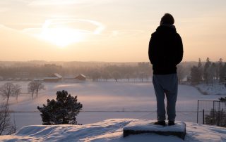 Man watching winter sunset