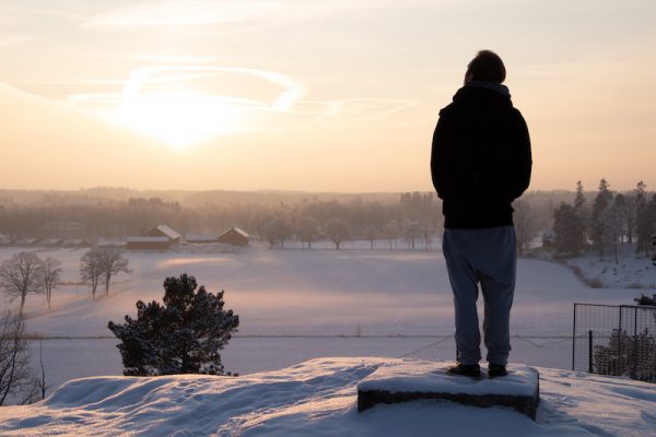 Man watching winter sunset