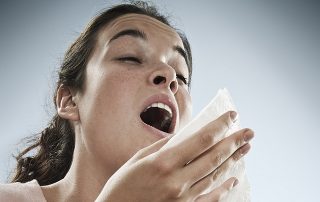 woman with cold sneezing