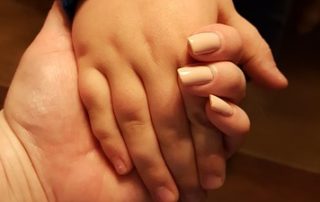 Adult holding a child's hand/adoption