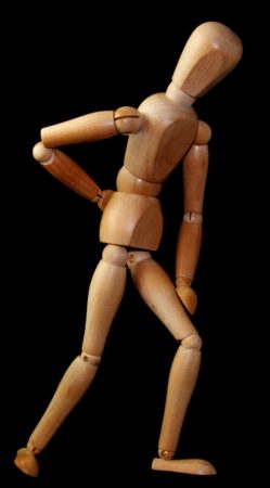 Wooden figure clutching back 