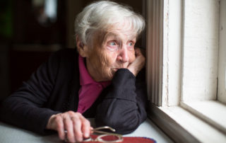 ElderlyElderly woman looking out window