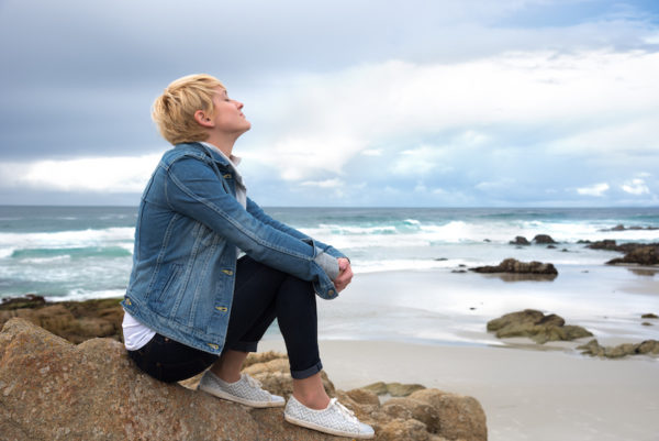 Woman relaxing at beach/Adobe