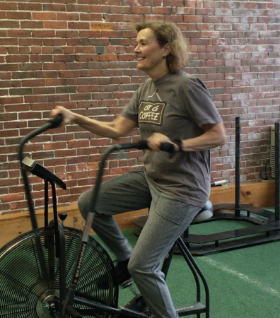 Diane at the gym on a bike