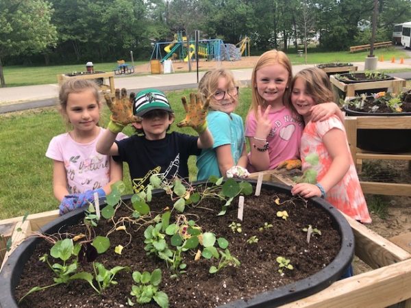 Kids planting at multigenerational garden