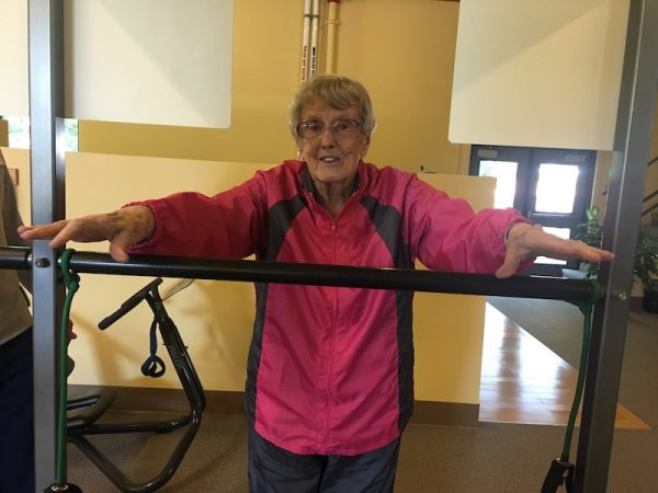 Ginny Hoy stretching at Basics Fitness Center