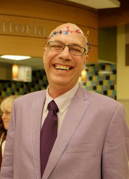 Tom Antonik wearing colorful garland on his head