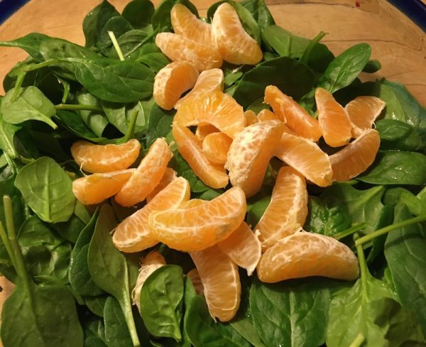 Spinach leaves and clementine sections