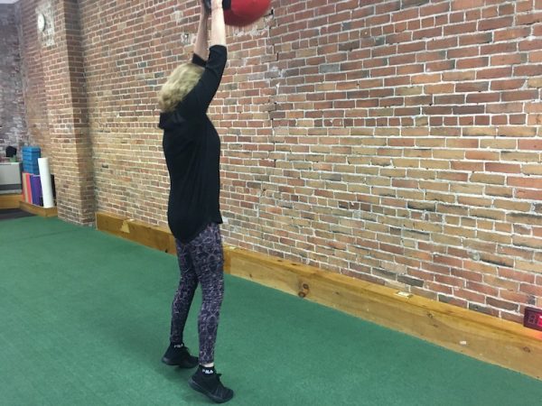 Diane Atwood slamming down a medicine ball while exercising