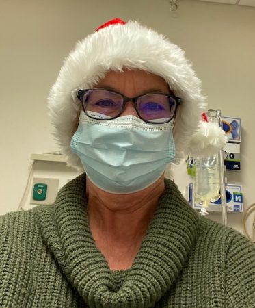 Kim Laramy, brain aneurysm patient, in Santa hat.
